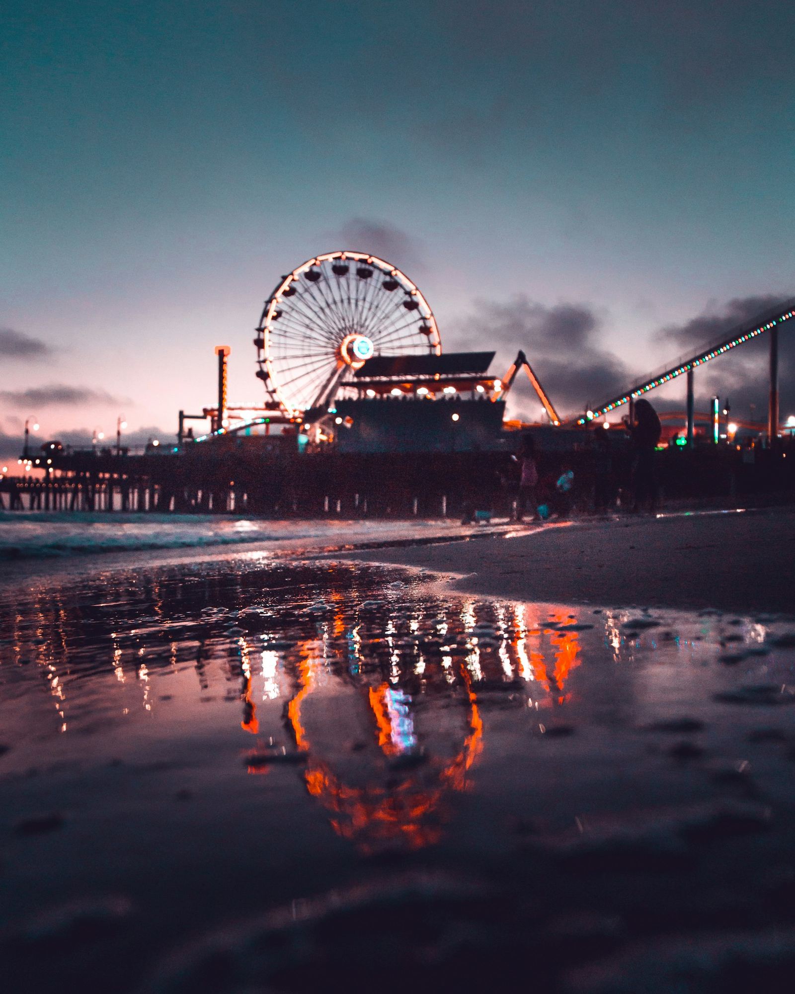 Santa Monica Pier ferris wheel silhouetted against a golden sky